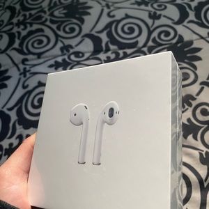 (BRAND NEW, STILL IN PLASTIC PACKAGING) AIRPODS w/ charging case